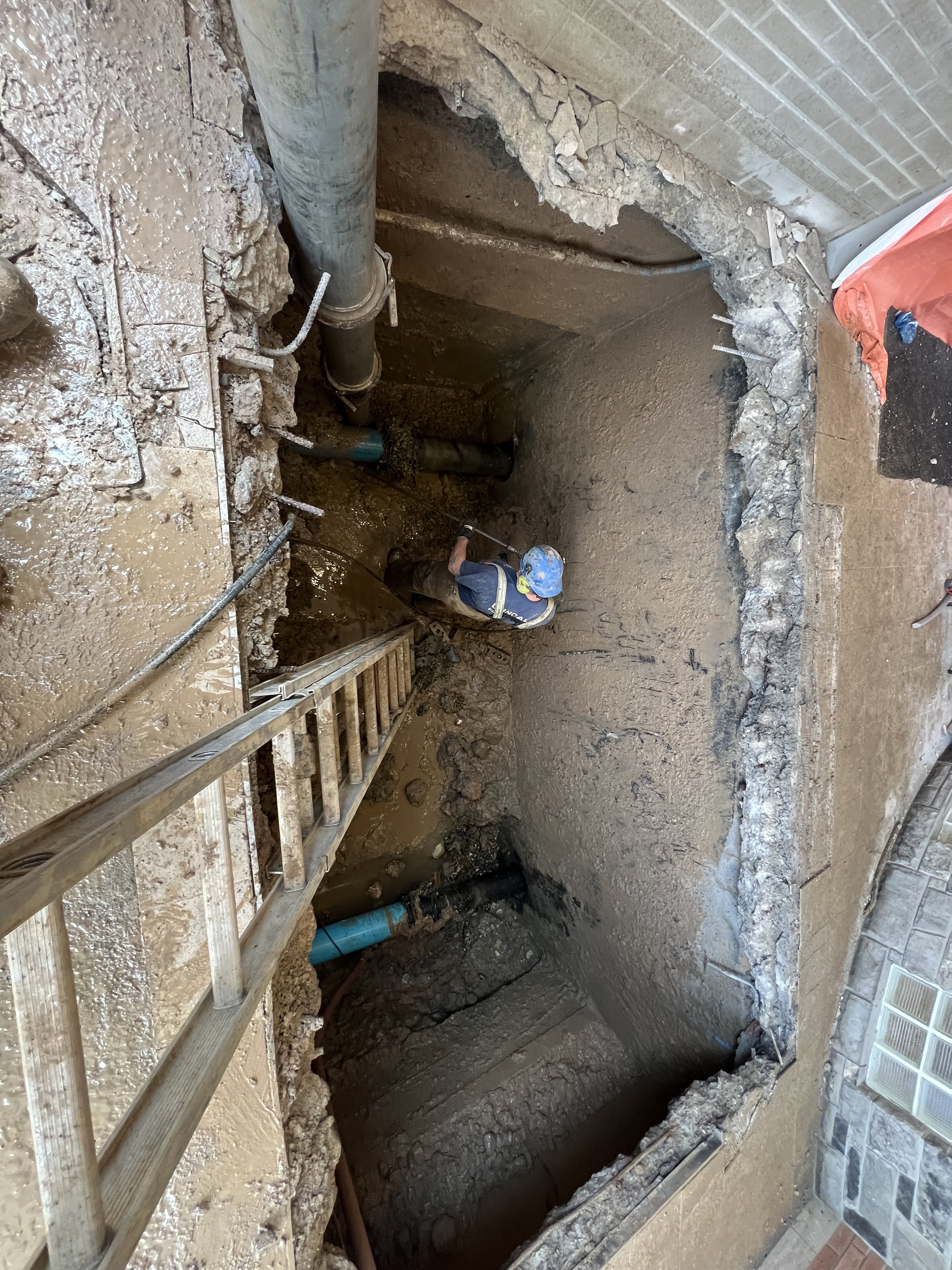 Worker in hydrovac excavation site